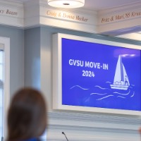 TV that says "GVSU MOVE IN 2024" with white text, blue background, and white sailboat graphic